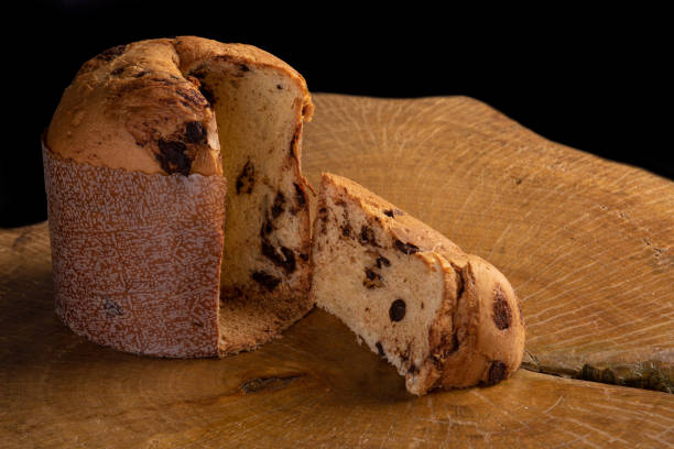 istock Panettone with chocolate chips on rustic wood with black background, selective focus. 1277818391