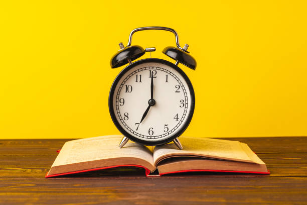 istock Books and alarm clock on table, education concept 1277818577