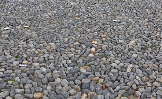 Pavement of the Piazza Grande, main square in the city center of Locarno, a city in Italian speaking canton in Switzerland. The round stones are cemented together.