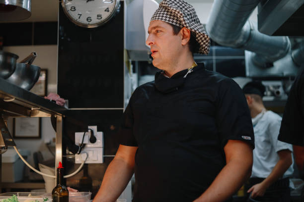 istock Restaurant kitchen coworkers preparing food 1277819763