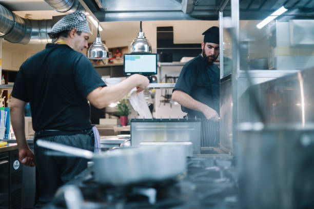 istock Restaurant kitchen coworkers preparing food 1277819845