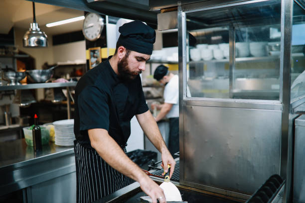 istock Restaurant kitchen coworkers preparing food 1277820015