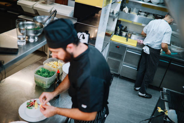 istock Restaurant kitchen coworkers preparing food 1277820108