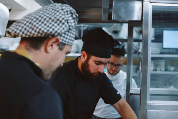 istock Restaurant kitchen coworkers preparing food 1277820344