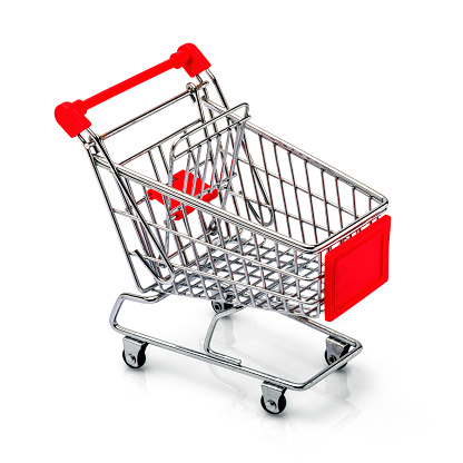 Asian woman pulling a shopping cart in a supermarket.