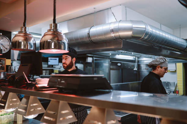 istock Restaurant kitchen coworkers preparing food 1277820643