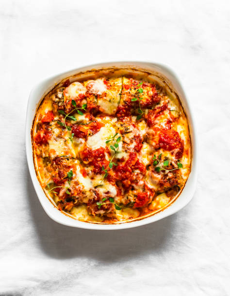 istock Zucchini cannelloni stuffed with meat with tomato sauce and mozzarella cheese on a light background, top view 1277820930