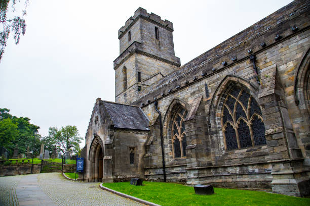 istock Gothic church entrance side facade with grass and cobblestones 1277822521