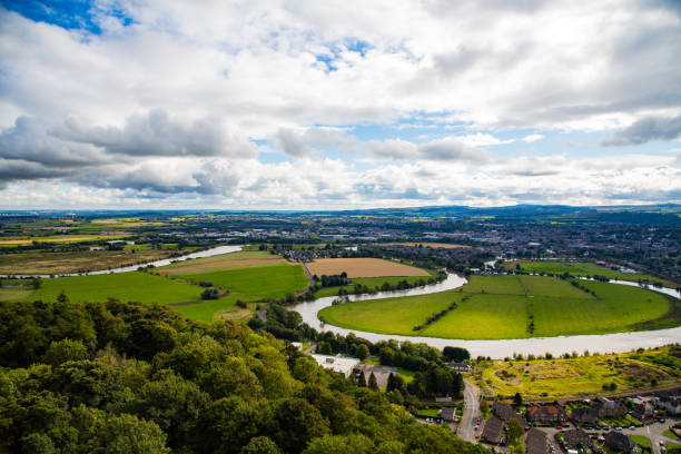 River bend view with trees and houses in the foreground and mountains in Stirling, Scotland, United Kingdom