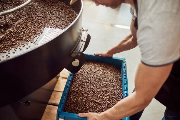 istock Male worker hands holding plastic crate with roasted coffee beans 1277822621