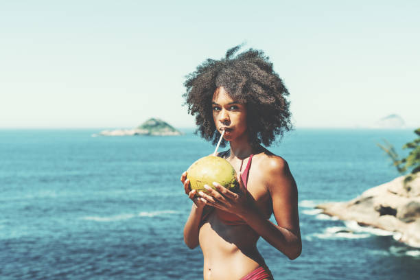 istock Black girl with coco on the beach 1277822759
