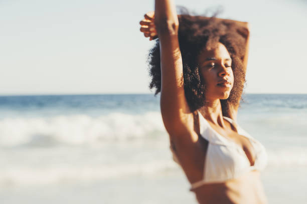 istock Black girl enjoys evening sun, beach 1277822896