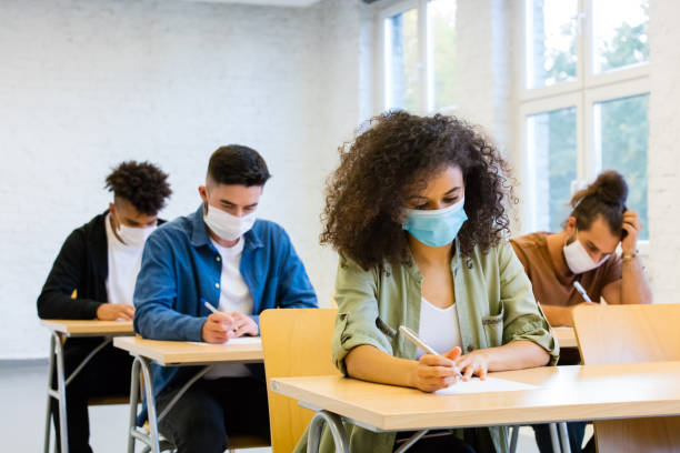 istock Students at the lecture during coronavirus pandemic 1277827430