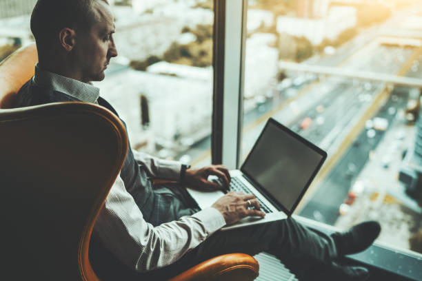 istock Businessman with laptop near window 1277827453