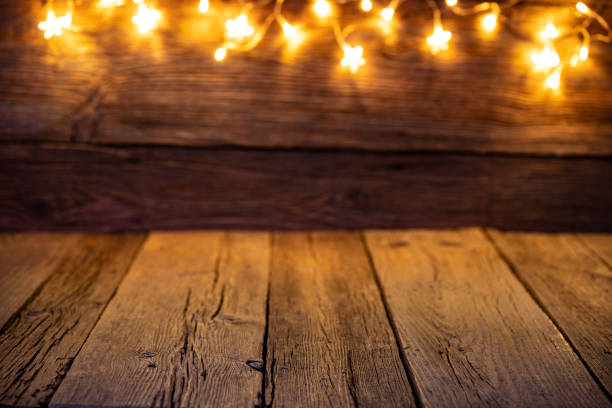 istock Christmas background with glowing blurred lights on rustic old wood 1277831276