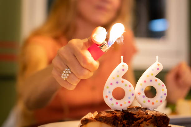 istock A young unrecognizable female lighting candles on a 66th birthday cake 1277831341