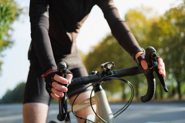 istock Hands of a cyclist resting on road bike handlebars. 1277831824