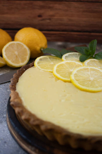 istock Fresh and homemade lemon pie or tart on rustic background 1277831917