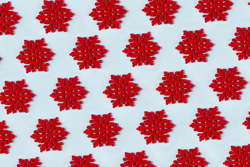 Christmas snowflake ornaments in a row on blue background