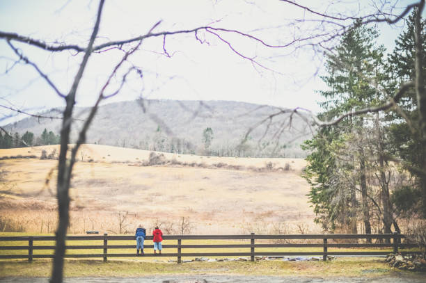 Landscape in fall with two kids in winter coats