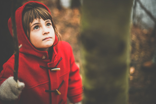 Solemn sweet child in a outdoor fall/winter portrait