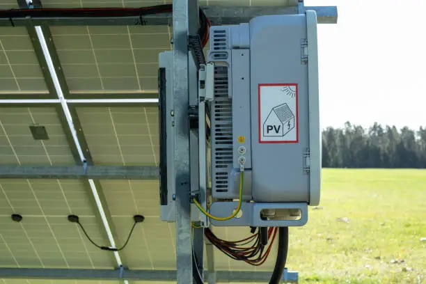 Huawei generator under solar panel on a green grass field