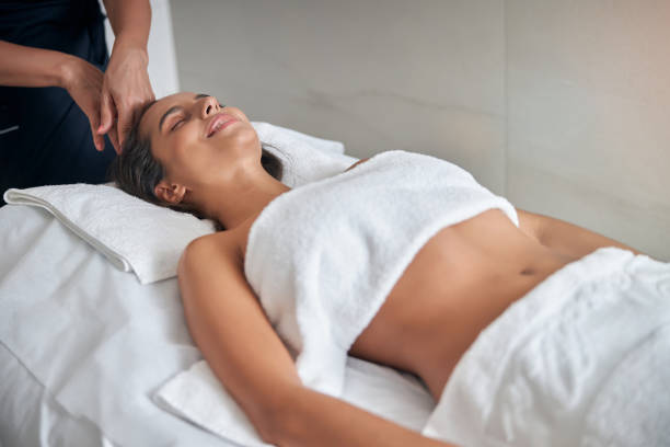 istock Masseur hands massaging female head in spa salon 1277836562