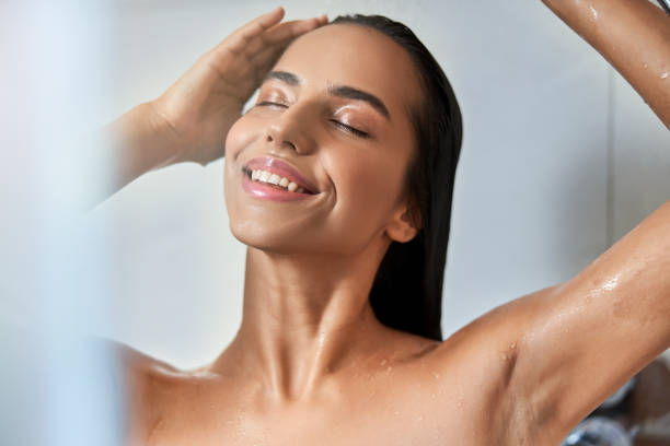 istock Attractive young woman taking shower at home 1277836570