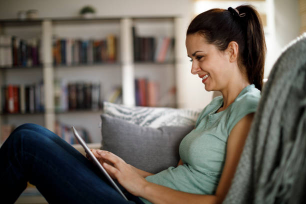 istock Smiling mature woman using digital tablet at home 1277837670