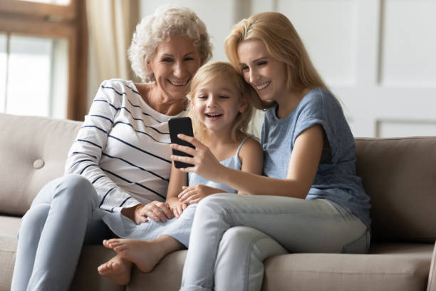 istock Laughing intergenerational family spending leisure time with smartphone at home 1277840274