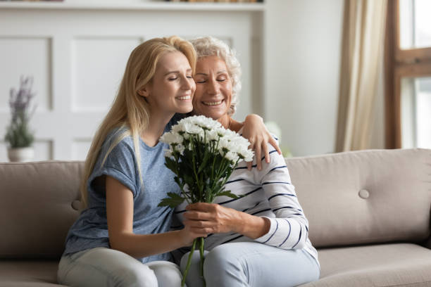 istock Affectionate grown up daughter cuddling aged mother congratulating with holiday 1277840298