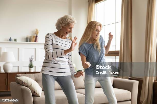 Aged Granny And Grown Granddaughter Dancing At Home Celebrating Housewarming Stock Photo - Download Image Now