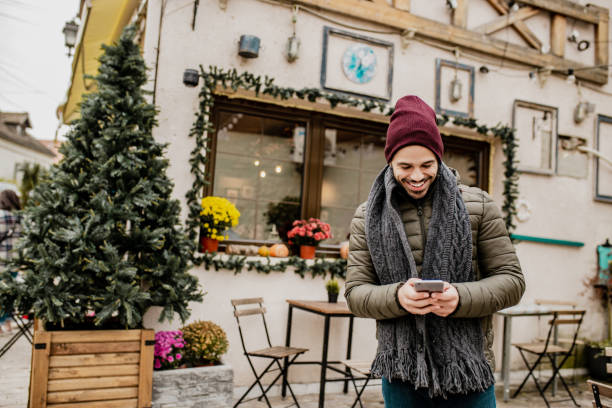 istock Young man on the street with smart phone during winter 1277841326