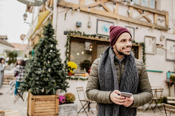 istock Young man on the street with smart phone during winter 1277841365