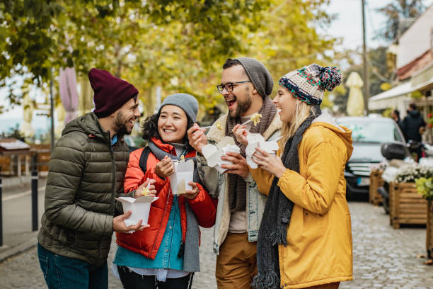 istock Group of friends outdoors eating fast food 1277841808
