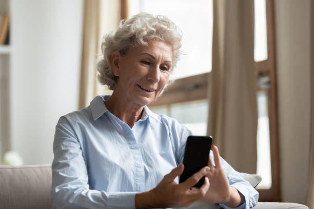 istock Happy elegant old lady using smartphone with confidence at home 1277845095
