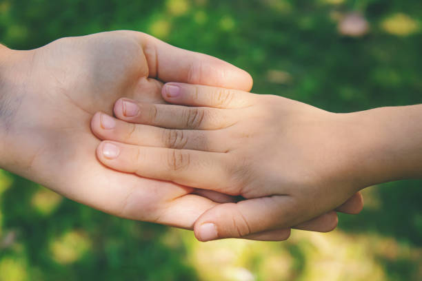 istock mom holding baby by the hand. selective focus 1277845728