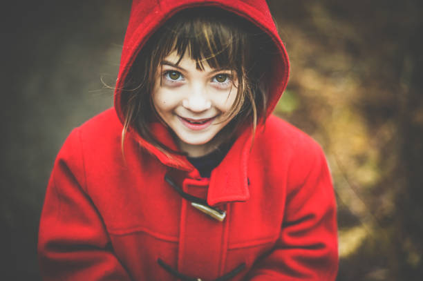istock Happy girl  in red coat outdoors in winter 1277846199