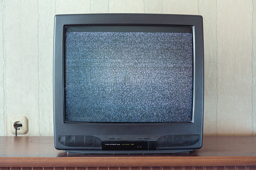 glith television analog signal on tv screen on wooden stand closeup front view