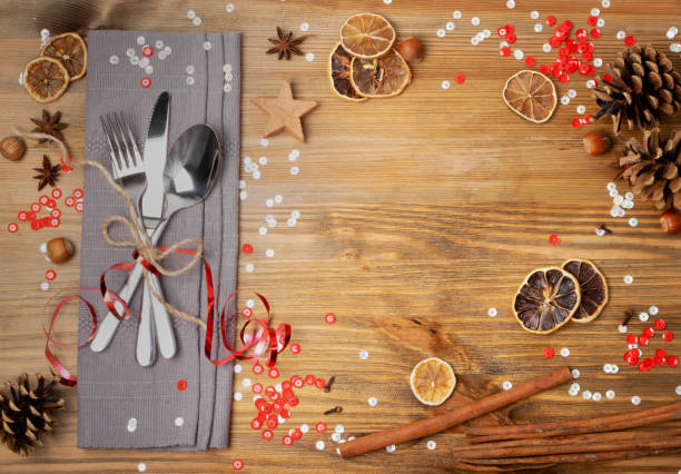 Christmas Dinner Table Setting with Cutlery, Grey Napkin and Winter Spices Top View. Festive Restaurant Decoration Background for Xmas Lunch, Dining invitation or Party with Copy Space