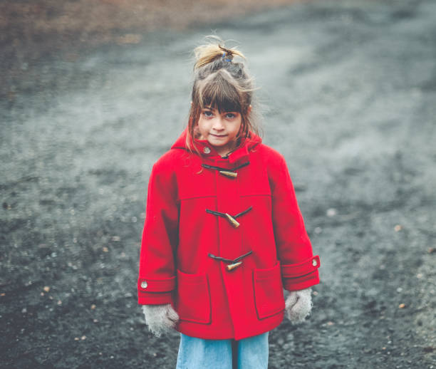 istock Messy child in winter coat outdoors 1277856812