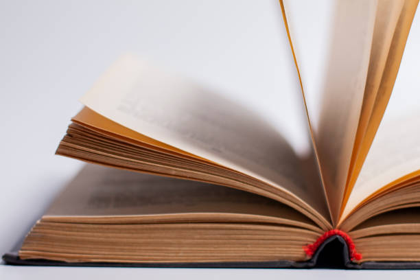 istock Open book on a white background with protruding pages. 1277857568