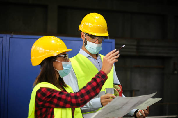 istock Factory workers work with face masks in the factory on a new project protecting themselves from the corona virus 1277858403