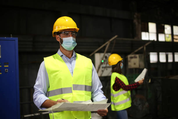 istock Factory workers work with face masks in the factory on a new project protecting themselves from the corona virus 1277858474