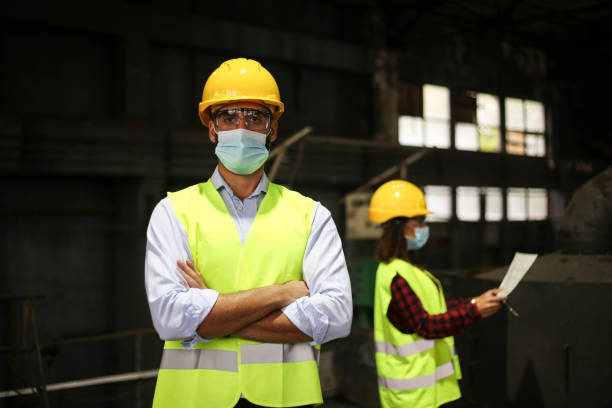 istock Factory workers work with face masks in the factory on a new project protecting themselves from the corona virus 1277858503