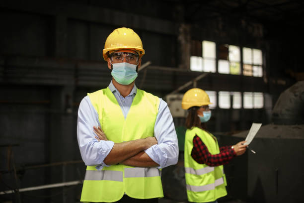 istock Factory workers work with face masks in the factory on a new project protecting themselves from the corona virus 1277858529