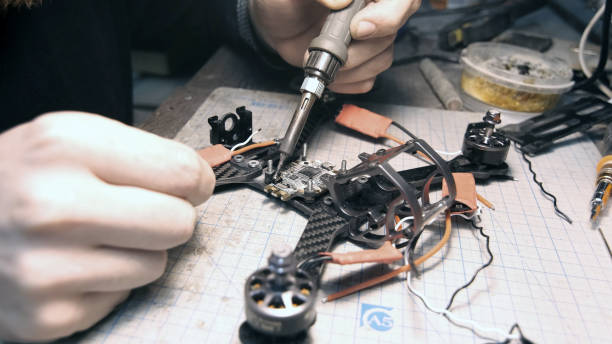 istock The guy solders the FPV chips of the drone. Front frame view 1277859244