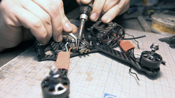 istock The guy solders the FPV chips of the drone. Front frame view 1277859258