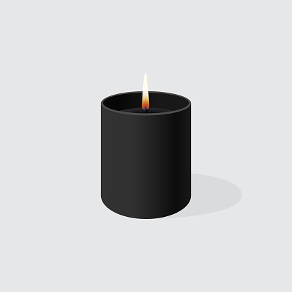 Aromatic decorative interior burning candle in a black glass or jar.