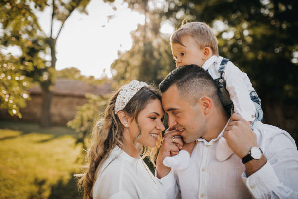 istock Happy family sitting on the grass 1277863101